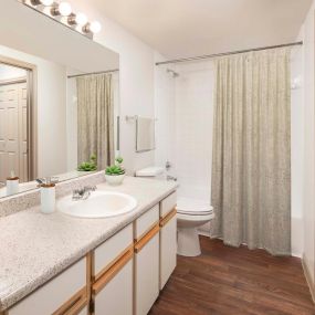 Bathroom single vanity with wood style flooring