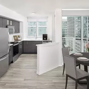 Apartment home kitchen and dining with city views at Camden Las Olas in Ft Lauderdale Florida