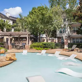 Swimming pool with sun loungers