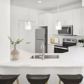 Renovated kitchen with white quartz countertops and stainless steel appliances at Camden St.Clair in Atlanta GA