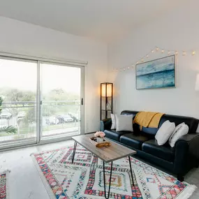 Open concept living room with balcony.