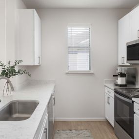 Kitchen with window and stainless steel appliances at Camden Spring Creek Apartments in Spring, Texas.