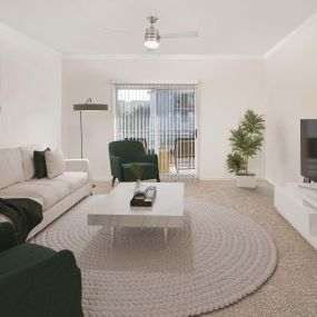 Spacious living room with attached balcony at Camden Spring Creek Apartments in Spring, Texas.