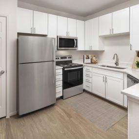 Kitchen with white cabinetry and granite countertops at Camden Spring Creek Apartments in Spring, Texas