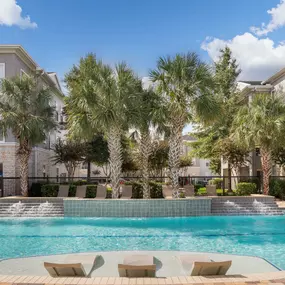 Resort-style pool with lounge chairs at Camden Spring Creek Apartments in Spring, Texas