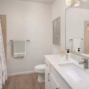 Bathroom with granite countertops and white cabinetry at Camden Spring Creek Apartments in Spring, Texas