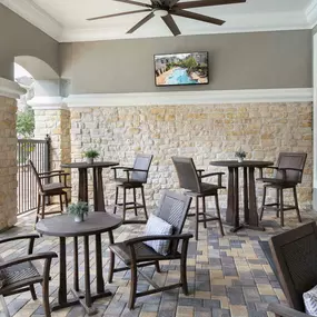 Outdoor lounge with TV at Camden Spring Creek Apartments in Spring, Texas