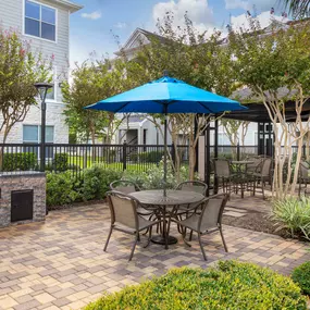 Outdoor dining and grill area at Camden Spring Creek Apartments in Spring, Texas