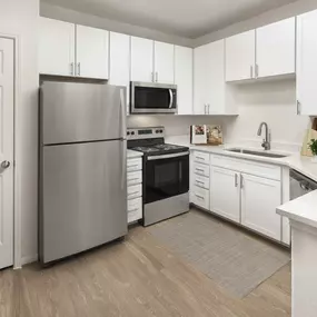 Kitchen with white cabinetry and granite countertops at Camden Spring Creek Apartments in Spring, Texas