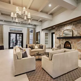 Resident lounge with seating and stone fireplace