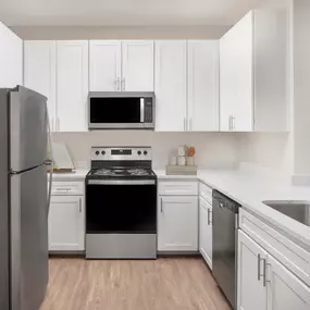 Kitchen with Stainless Steel Appliance, white cabinetry and quartz countertops at Camden Spring Creek Apartments in Spring, TX