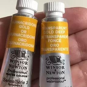 Notice the difference between the two tubes? 

Basically they are the same color. However, we’ve learned the pigment, Pigmenr PR206, in Quinacridome Gold Deep will be changing. It will soon change to PR179. To reflect the change, Winsor and Newton is changing the name of the color. It will now be known as Transparent Gold Deep.
 
The resulting color is a very close substitute of Quinacridone Gold.