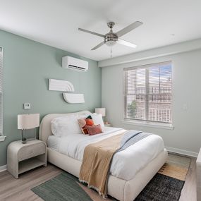 Bright bedroom with a ceiling fan at Glen Oaks Apartments in Wall Township, NJ.