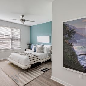 Bright bedroom with a ceiling fan at Glen Oaks Apartments in Wall Township, NJ.