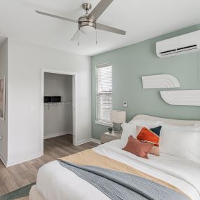 Bright bedroom with a ceiling fan at Glen Oaks Apartments in Wall Township, NJ.