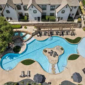 Aerial view of buildings overlooking resort-style pool at Camden Brushy Creek apartments in Austin, TX