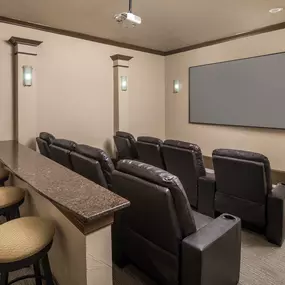 Community movie theater room with tiered seating at Camden Brushy Creek apartments in Austin, TX