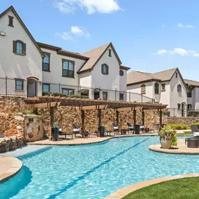 Resort-style pool with waterfall feature at Camden Brushy Creek apartments in Austin, TX