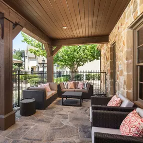 Poolside, covered patio lounge at Camden Brushy Creek apartments in Austin, TX