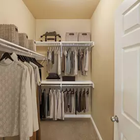 Walk-in closet with built-in wood shelves at Camden Brushy Creek apartments in Cedar Park, TX