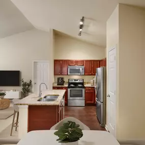 Dining area and kitchen with vaulted ceilings at Camden Brushy Creek apartments in Cedar Park, TX