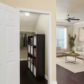 Living room with storage closet under the stairs and wood-style floor at Camden Brushy Creek apartments in Cedar Park, TX