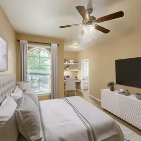Bedroom with built-in desk and shelves plus spacious walk-in closet at Camden Brushy Creek apartments in Cedar Park, TX