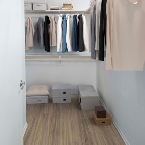 Beautifully renovated closet with wood shelving and rods.