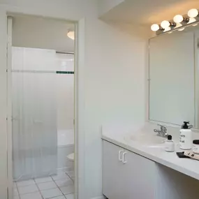 Bathroom with tile flooring and garden bathtub with tile surround