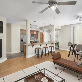 Open concept living room with fireplace and dining room near kitchen island with barstool seating