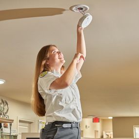 Mrs. Michael Electrician Working on smoke detector/ fire alarm system.