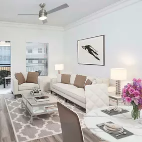 Beautifully renovated living room featuring crown molding and ceiling fan with LED lighting.