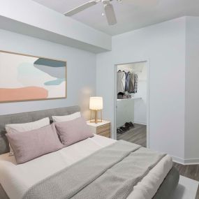 Bedroom with ceiling fan and spacious walk in closet
