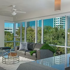 Living room with floor to ceiling windows at Camden Thornton Park apartments in Orlando, FL