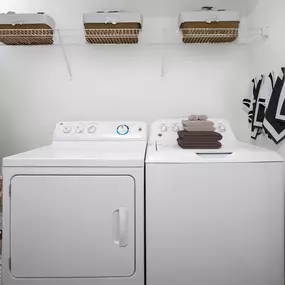 Washer and dryer with shelving at Camden Thornton Park apartments in Orlando, FL