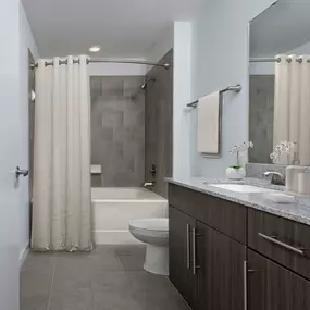 Bathroom with curved shower rod at Camden Thornton Park apartments in Orlando, FL