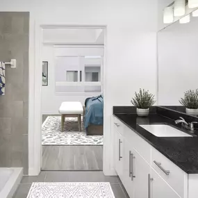 Ensuite bath with walk-in shower in white finish style at Camden Thornton Park apartments in Orlando, FL