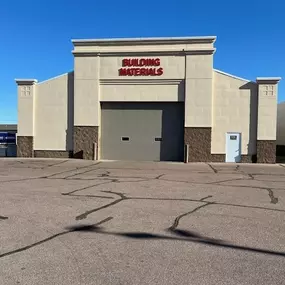 A beige building with a large sign reading 