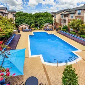 Pool deck with lounge chairs outdoor dining and barbeques