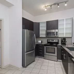 Kitchen with attached laundry room at Camden Fairfax Corner in Fairfax, Virginia