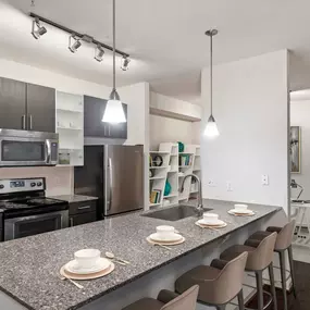 Kitchen with island seating at Camden Fairfax Corner in Fairfax, Virginia