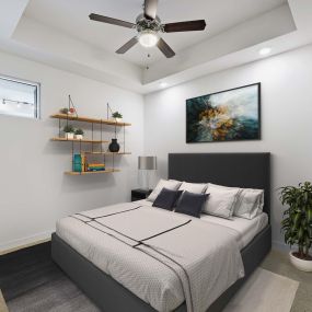 Bedroom with ceiling fan carpet high ceilings and carpet flooring