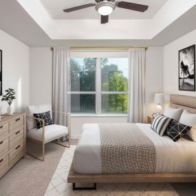 Bedroom with ceiling fan and plush carpet at Camden Rainey Street apartments in Austin, TX