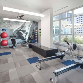 Yoga area and rowing machines in the 24-hour fitness center at Camden Rainey Street