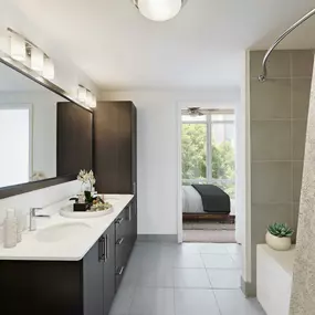 Bathroom with tile flooring dual vanity sinks bathtub with tile surround and curved shower rod