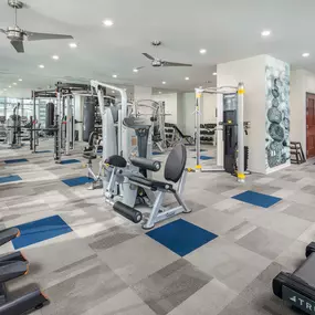 24-hour fitness center with various cardio and strength machines and equipment at Camden Rainey Street apartments in Austin, TX