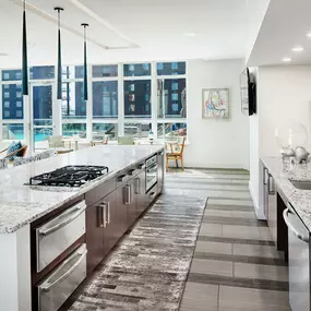 Resident clubroom kitchen overlooking rooftop pool