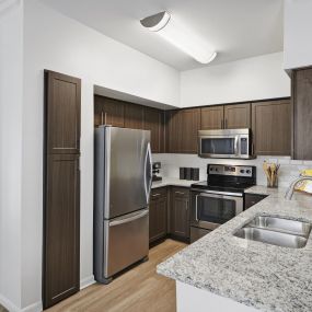 Contemporary-style kitchen with stainless steel appliances at Camden Farmers Market Apartments in Dallas, TX