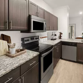 Contemporary-style kitchen with granite countertops and white subway-tile backsplash at Camden Farmers Market in Dallas, Tx