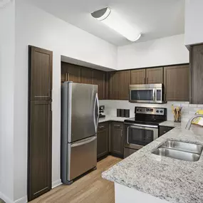 Contemporary-style kitchen with stainless steel appliances at Camden Farmers Market Apartments in Dallas, TX